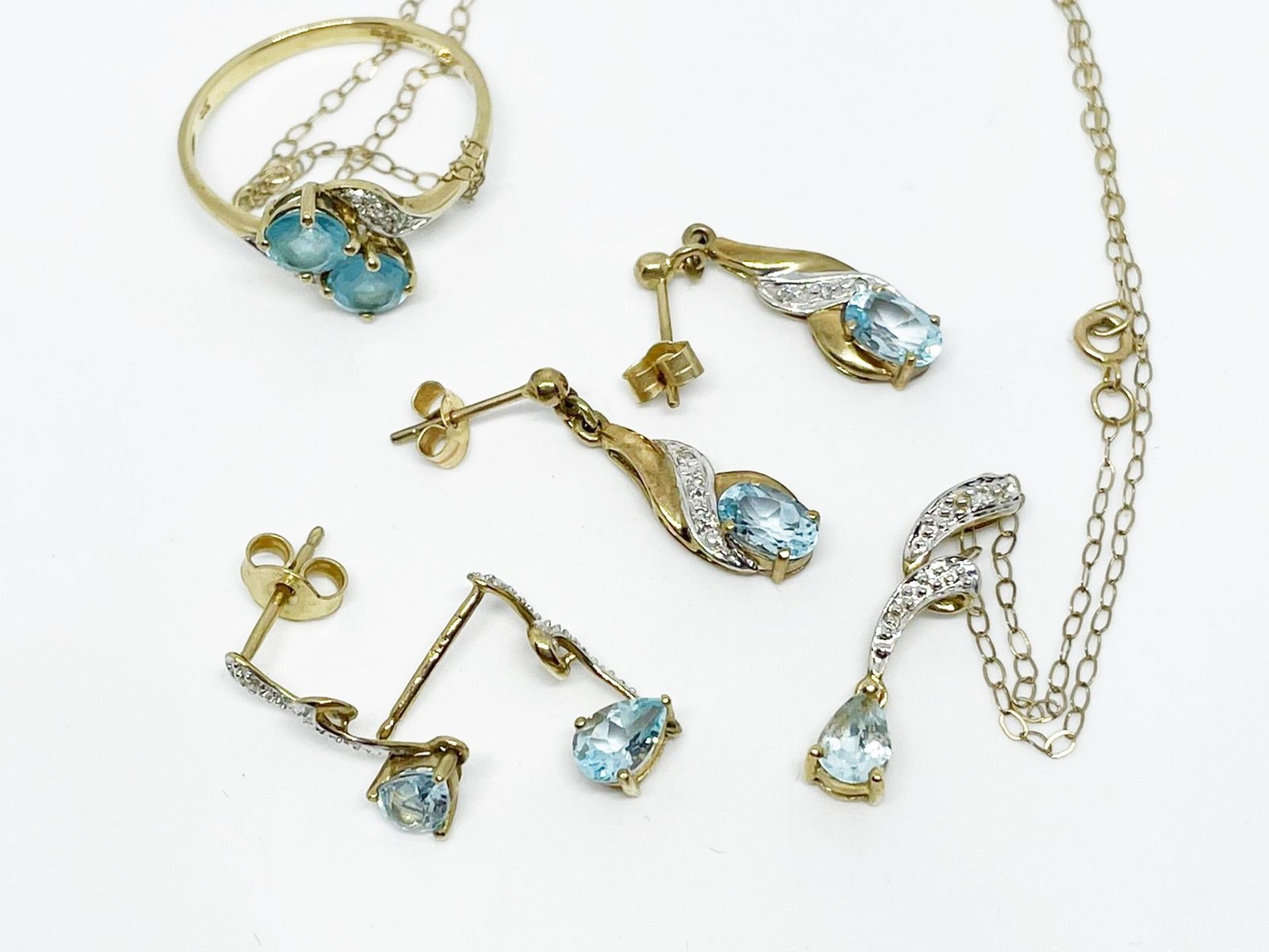 9 ct gold assorted blue topaz and diamond earrings, ring and necklace