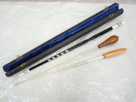 Cased and lacquered spiral mounted conductors baton