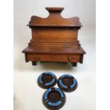 A wooden pipe stand with drawer and three Bakelite ashtrays advertising Tennents Lager Stout W: