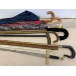 Various walking sticks and umbrellas etc.