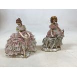 Two Dresden lace figurines one with a Borsoi and the other in a seated position. Lace losses to both