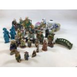 A large quantity of Chinese Mud Men figurines, dragon dogs and a turquoise glazed figures. Tallest