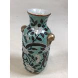 A 19th Chinese porcelain vase decorated with dragon and white blossom, gilded handles and top. No