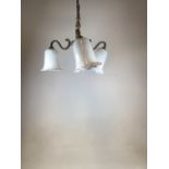 A early twentieth century brass ceiling light with 3 opaque white glass shades. One arm slightly