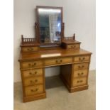 A large pine dressing chest with nine drawers to base, the top with large swing mirror flanked by