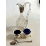 A Pair of silver salts with liners also with a silver spoon and a silver collared vinegar bottle.