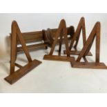 A collection of early to mid 20th century oak book or picture stands and book slides. Slides W: