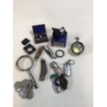 A quantity of magnifying glasses, pen knives, lighters and a ring gauge