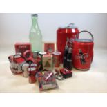 A quantity of branded Coca Cola items including a fridge, radio, phone, umbrellas and other items.