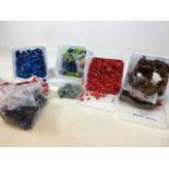 Four tubs of mixed loose Lego bricks including a range of colours, boat hulls, transparent blocks