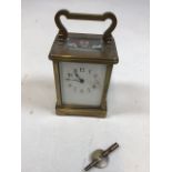 Brass Carriage clock with bevel edge top window, sides and back. Enamel dial - damage to enamel