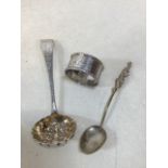 A silver hallmarked sugar spoon pierced and decorated with fruits in bowl. Monogrammed handle also