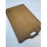 A vintage chopping board with handle. W:38cm x H:63cm