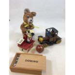 A battery operated tin toy car of a model Ford with a battery operated drumming Teddy a mouse