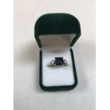 A square cut sapphire and diamond ring in 18ct gold