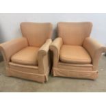 A Pair of upholstered arm chairs ion castors.