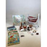 Four Rupert annuals form the 1970s, a dolls cot, dolls house furniture, a Peter Rabbit clock and