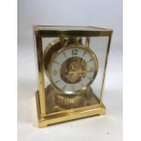 A Jaeger Le Coutre Atmos Classic V clock, with booklet. W:18cm x D:13.5cm x H:22cm