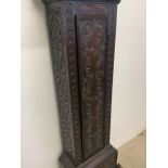 A heavily carved grandfather clock with brass and silvered face marked Sam Harley, Salop. With