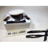 A Royal Naval officers cap belonging to Mr J G C Lander also with epaulettes and another hat band,