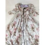 A hand made vintage shepherdess style ruched dress in printed cotton. Cross laced bodice with lace