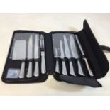 A set of Chef style stainless steel knives in case