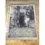 A signed etching, Behind the Church, Dartmouth. Dated 1915 indistinctly signed, also with other