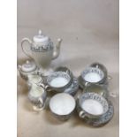 A part service of Wedgwood Dolphins including a coffee pot, milk jugs, sugar bowls and soup cups and
