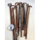A quantity of walking sticks and a shooting stick