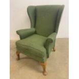 An upholstered wing back arm chair. Seat height H:43cm W:73cm x D:80cm x H:95cm
