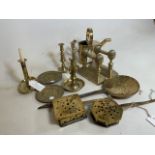 A large collection of brassware items to include firedogs, candle sticks, telescopic, chamber sticks