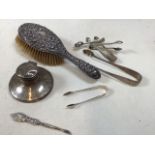 A silver backed hair brush, weighted ink well, sugar nips and other - all hallmarked with other