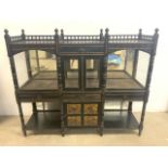 An aesthetic movement late 19th century ebonised wood and glazed cabinet. With three section