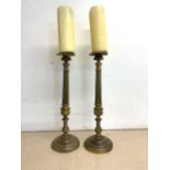 A pair of metal candle sticks. H:47cm