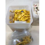 Three tubs of loose Lego, a tub of yellow, a tub of mainly black and a tub of white