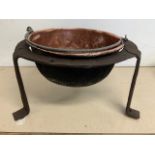 A Wrought iron stand with copper riveted bowl insert with metal handle. W:54cm x D:54cm x H:33cm