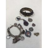 A silver charm bracelet, a silver sweetheart brooch, St Christophers and two presentation sporting