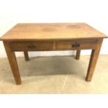 An early 20th century rustic oak table with two drawers. W:121cm x D:76cm x H:76cm