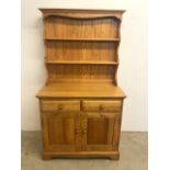 A modern pine Ercol two piece dresser. W:92cm x D:46cm x H:167cm