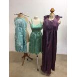 Three mid century satin evening dresses. One embellished with floral sequinned applique, and one