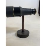 A Pair of binoculars on wooden and metal mount. H:20.5cm