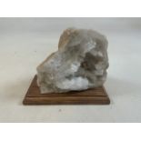 A quartz geode on Oak plinth.