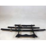 A set of 3 replica Samurai swords. Longest 98cm