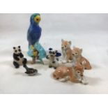 A trio of Lomonosov Russian lions also with a ceramic mid century parrot and other animals