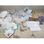A quantity of vintage table linen some embroidered. Includes table cloths, napkins and lace doilies.