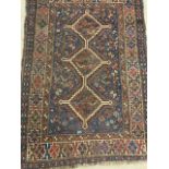 An antique Qashqai rug. W:110cm x H:152cm