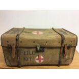 A large military canvas and wooden bound trunk with leather straps . Stencilled with Feild kit W: