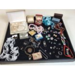 A quantity of costume jewellery includes earrings, brooches and others in a Ralph Lauren tin dated