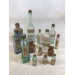 A quantity of glass and stoneware medical bottles with vintage labels