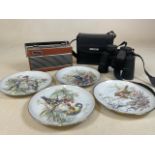 A cased pair of Opticron binoculars a Roberts radio and four bird plates to include a stunning